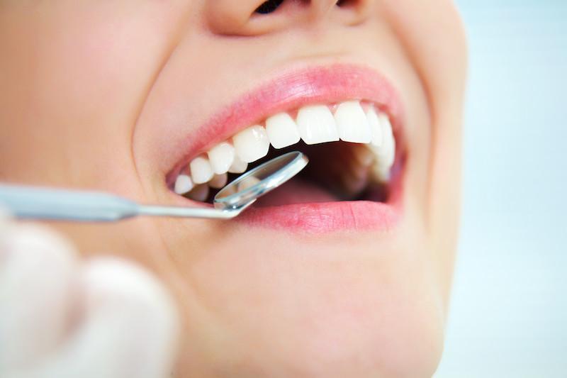 Woman getting dental cleaning | Gretna LA Dentist