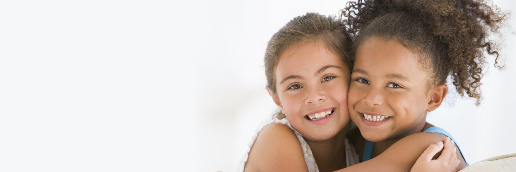 two young girls hugging | dentist Gretna LA