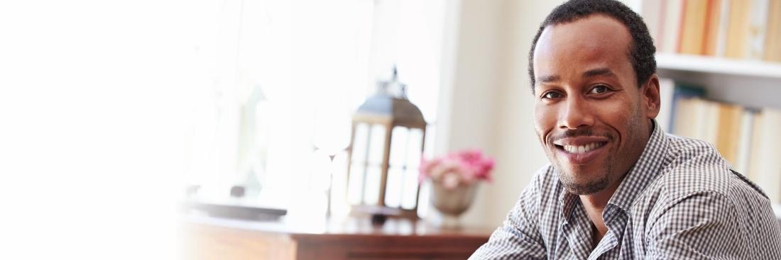 man smiling at desk | dentist gretna la