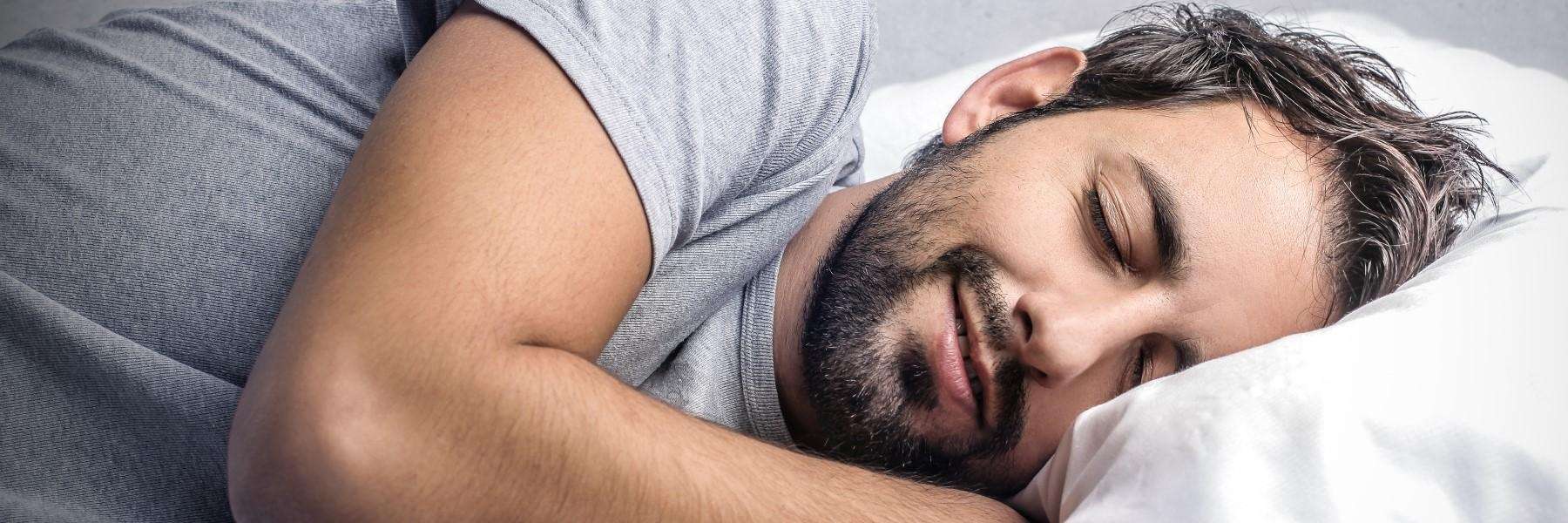 Man peacefully sleeping on pillow highlighting How Sleep Apnea Affects Your Health and wellness risk