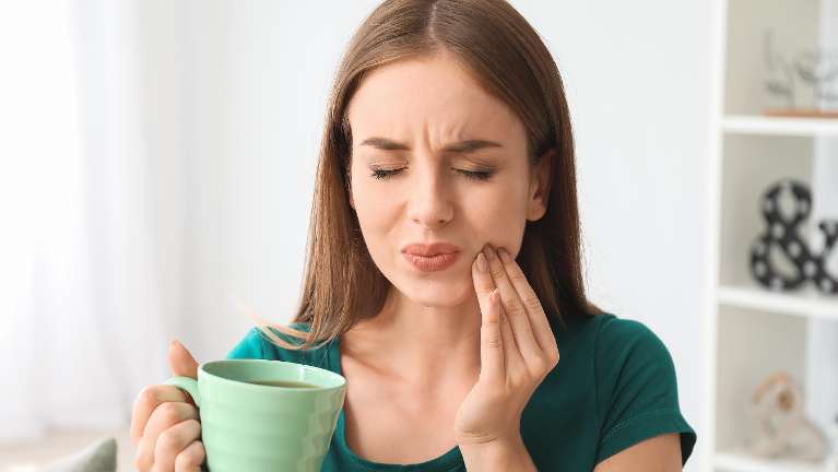 Woman suffering from dental pain
