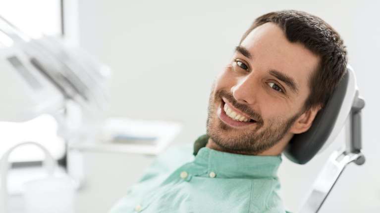 dental exam and cleaning gretna | man at dentist