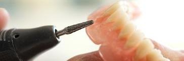 dental drill against a denture