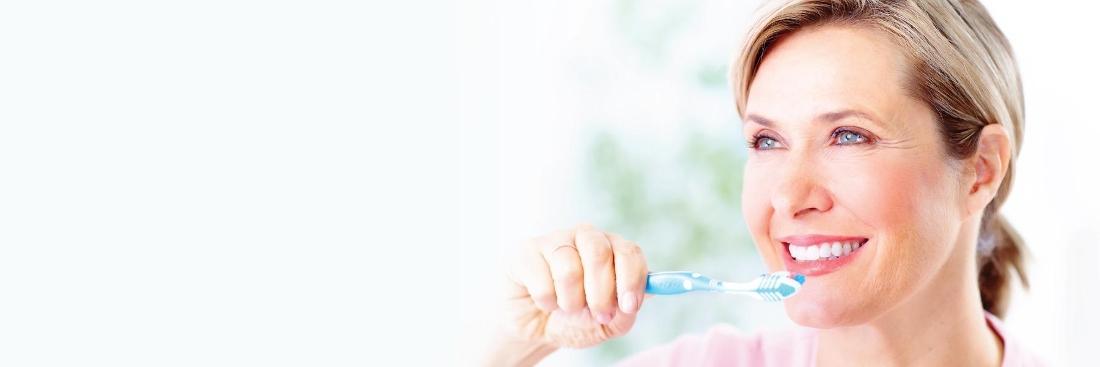 woman brushing her teeth | Dentist Gretna LA
